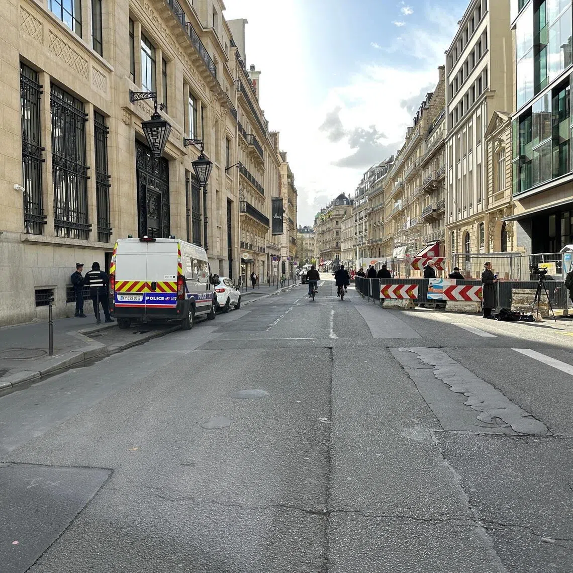 Police and private security vehicles outside the Bank of America building in the 8th arrondissement of Paris on March 28, following an apparent bomb attack attempt.