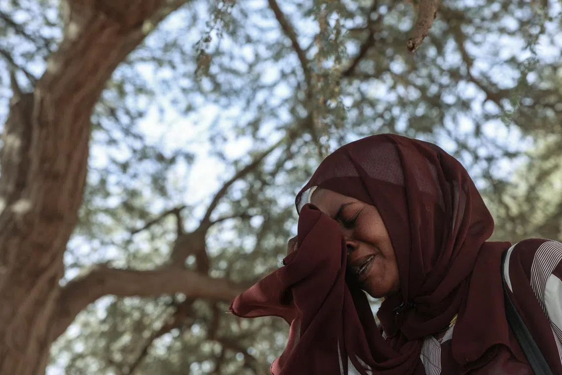 Mona Mohamed, 33, a Sudanese refugee who fled Al-Fashir, reacts during an interview with Reuters, amid ongoing conflict in Sudan between the paramilitary Rapid Support Forces (RSF) and the Sudanese army, at the Iridimi refugee camp, northwest of the town of Iriba, in Wadi Fira province, eastern Chad, November 27, 2025. REUTERS/Amr Abdallah Dalsh