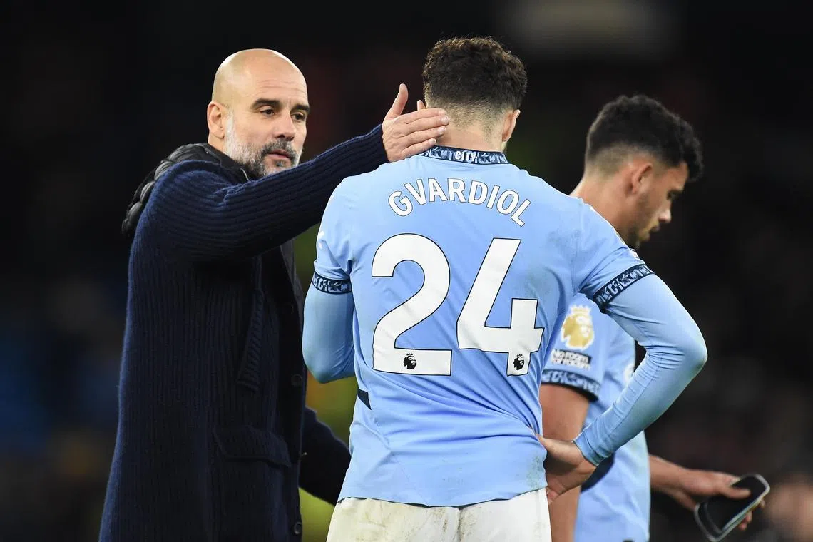 epa11779374 Manchester City's manager Pep Guardiola (L) and his player Josko Guardiol react after losing again in the English Premier League against Manchester United, in Manchester, Britain, 15 December 2024.  EPA-EFE/PETER POWELL