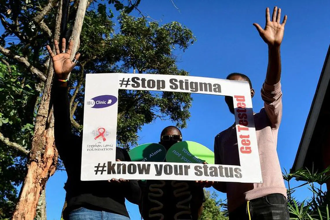 FILE PHOTO: HIV/AIDS patients and LGBTQ members hold an advocacy placard at the Ice Breakers Uganda (IBU) clinic in Makindye that supports HIV/AIDS programmes and treatment for the LGBTQ community in Salaama road, Kampala, Uganda June 1, 2023. REUTERS/Abubaker Lubowa