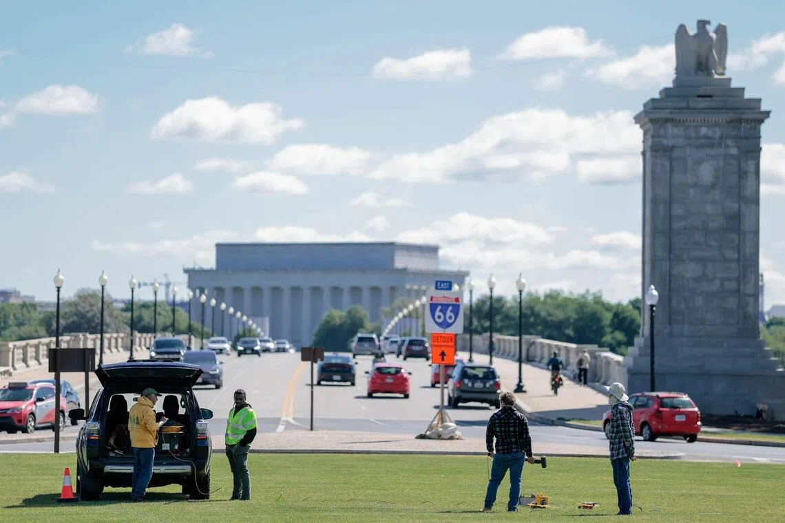 Workers take measurements at Memorial Circle, the proposed site for U.S. President Donald Trump's "Triumphal Arch", in Washington, D.C., U.S., May 15, 2026. REUTERS/Kylie Cooper