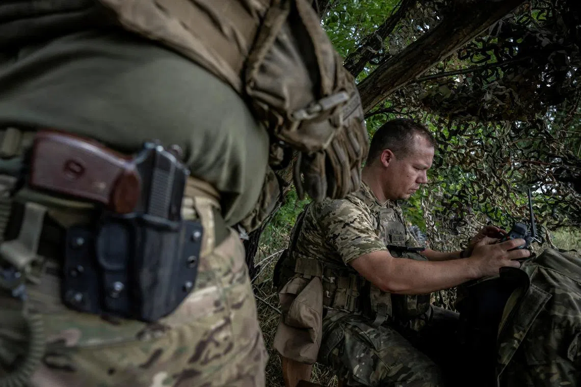 A Ukrainian serviceman operates an FPV drone, from a front-line position near the village of Robotyne, in Ukraine's Zaporizhzhia region.
