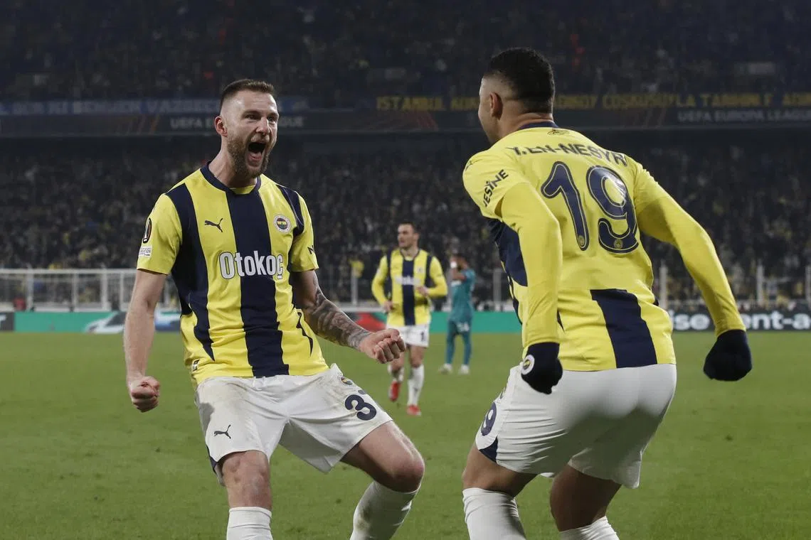 Soccer Football - Europa League - Knockout Phase Playoff - First Leg - Fenerbahce v Anderlecht - Sukru Saracoglu Stadium, Istanbul, Turkey - February 13, 2025 Fenerbahce's Youssef En-Nesyri celebrates scoring their third goal with Fenerbahce's Milan Skriniar REUTERS/Dilara Senkaya