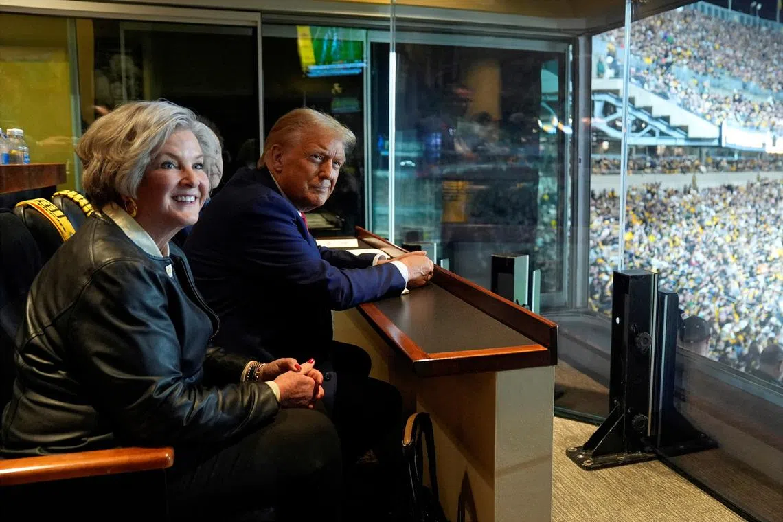 Republican presidential candidate and former President Donald Trump sits with Susie Wiles as he attends the New York Jets football game against the Pittsburgh Steelers at Acrisure Stadium, Sunday, Oct. 20, 2024, in Pittsburgh. Evan Vucci/Pool via REUTERS/File Photo