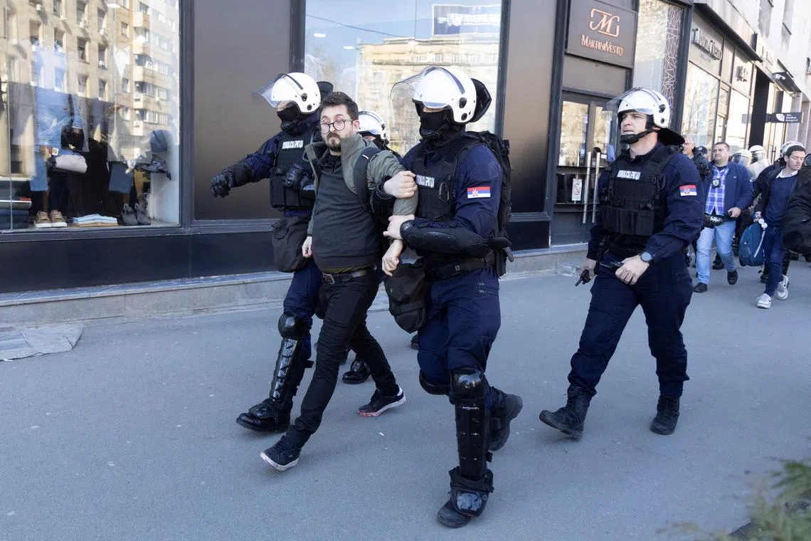 Police officers detain people during a protest in Belgrade, Serbia, March 6, 2025. REUTERS/Djordje Kojadinovic/File Photo