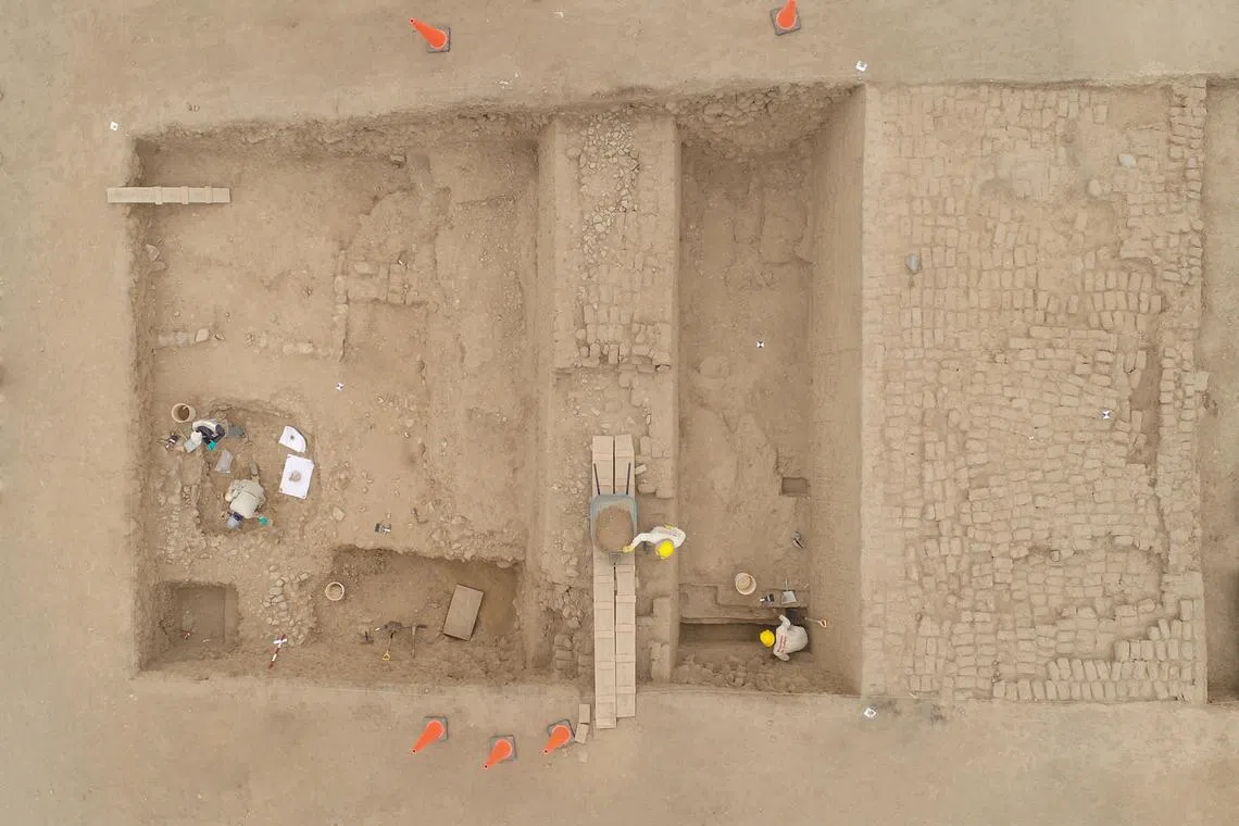 A drone image shows archaeologists working on a site where they discovered the remains of what is believed to be wealthy members of the Chimu civilization, a pre-Inca society that thrived for centuries in arid plains nestled between the Pacific Ocean and Andes Mountains, in Trujillo, Peru, in this undated handout picture obtained by Reuters on July 8, 2024.  Peru's Ministry of Culture/Handout via REUTERS