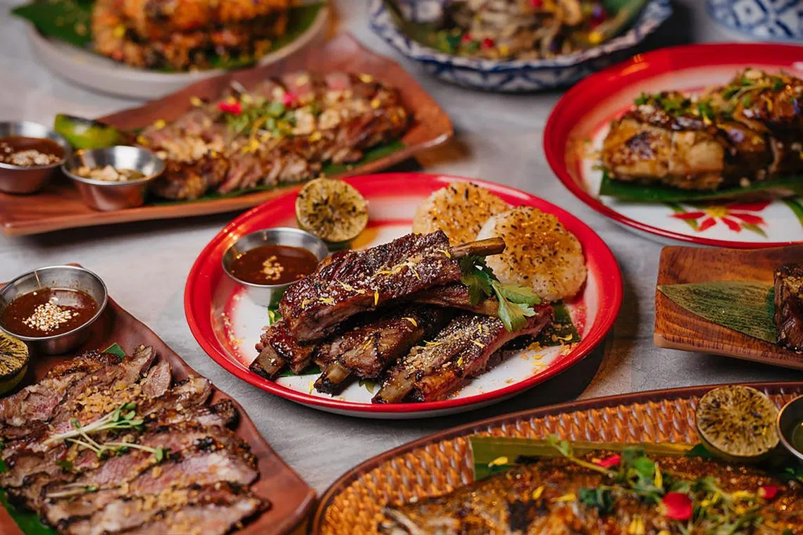 Fi's Signature "Moo Ping" Pork Rib ($48, 500g bone-in), slow-grilled over lychee wood until tender, then flame-kissed for the perfect charred ends. 