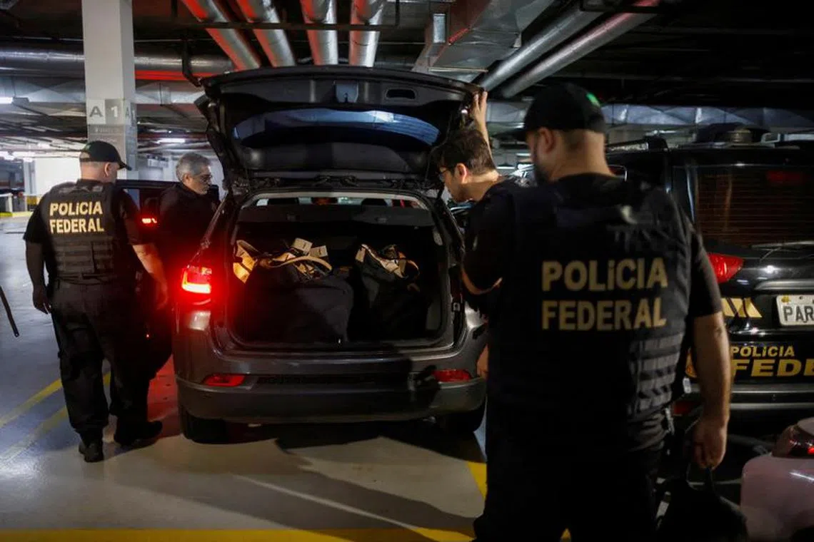 FILE PHOTO: Federal police officers leave the headquarters of the Liberal Party during an operation targeting some of former President Jair Bolsonaro's top aides in Brasilia, Brazil February 8, 2024. REUTERS/Adriano Machado/File Photo
