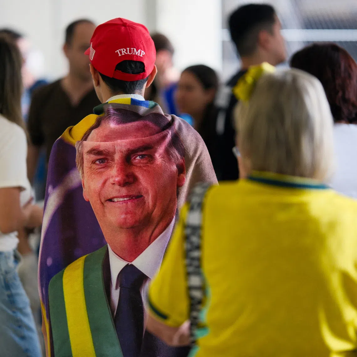 A person wears an image of Brazil's former president Jair Bolsonaro and a US President Donald Trump hat, during the general election, in Brasilia, Brazil, October 4, 2026. REUTERS/Diego Herculano