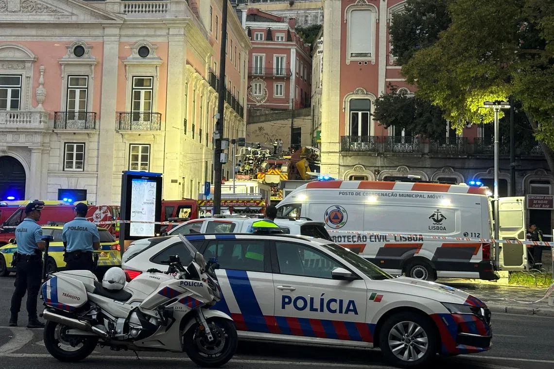 First responders work at the site of an accident at Lisbon's Gloria funicular, a popular tourist attraction, which derailed and crashed, resulting in fatalities and injuries, according to authorities, in Lisbon, Portugal, September 3, 2025. REUTERS/Miguel Pereira/File Photo