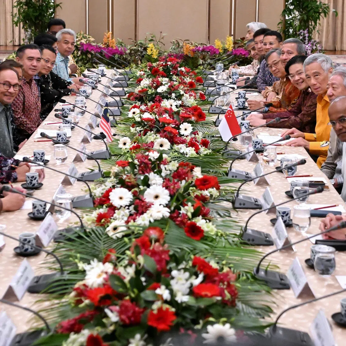 PM Lee Hsien Loong (sixth from right) and Malaysian PM Anwar Ibrahim (fifth from left) with the ministers from both countries at a delegation meeting at the Istana on Oct 29, 2023.