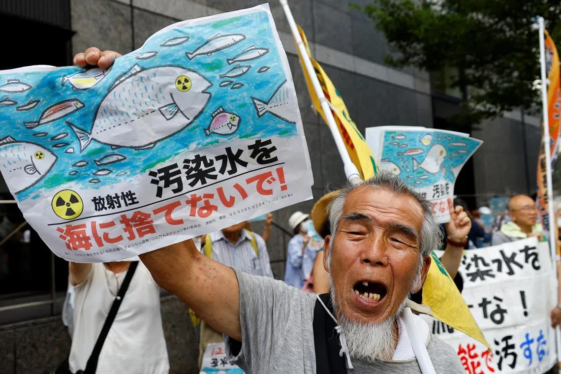 A protester holds a card reading "No radiation contaminated water into the sea" during a rally against Japan's plan to discharge treated radioactive water, on Aug 24.