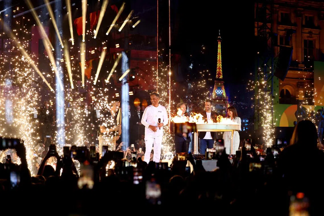 Former tennis player Yannick Noah, President of the Organising Committee of the Paris 2024 Olympic and Paralympic Games Tony Estanguet, presenter Stephane Bern and Mayor of Paris Anne Hidalgo during the lighting of the cauldron ceremony on July 14.