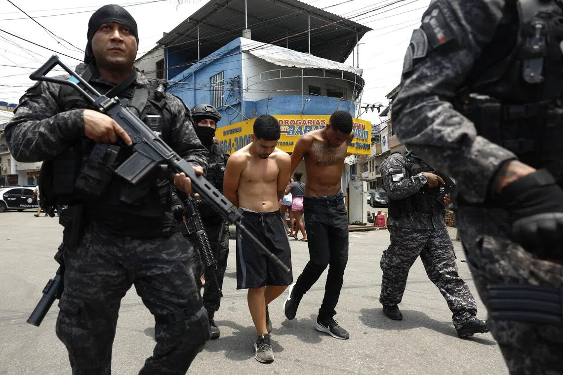 Police officers in Rio de Janeiro detaining people on Oct 28, during an operation  ahead of COP30-related events in the city.