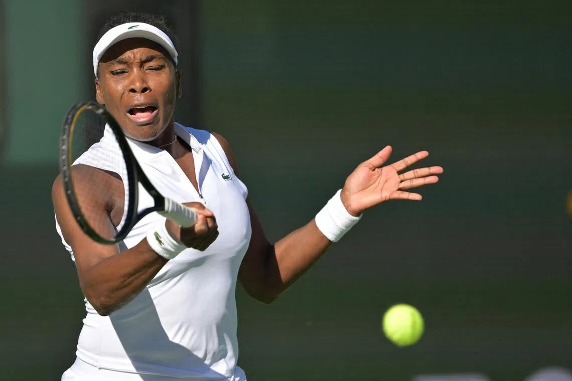 Venus Williams hits a shot during her first-round match against Diane Parry at Indian Wells.