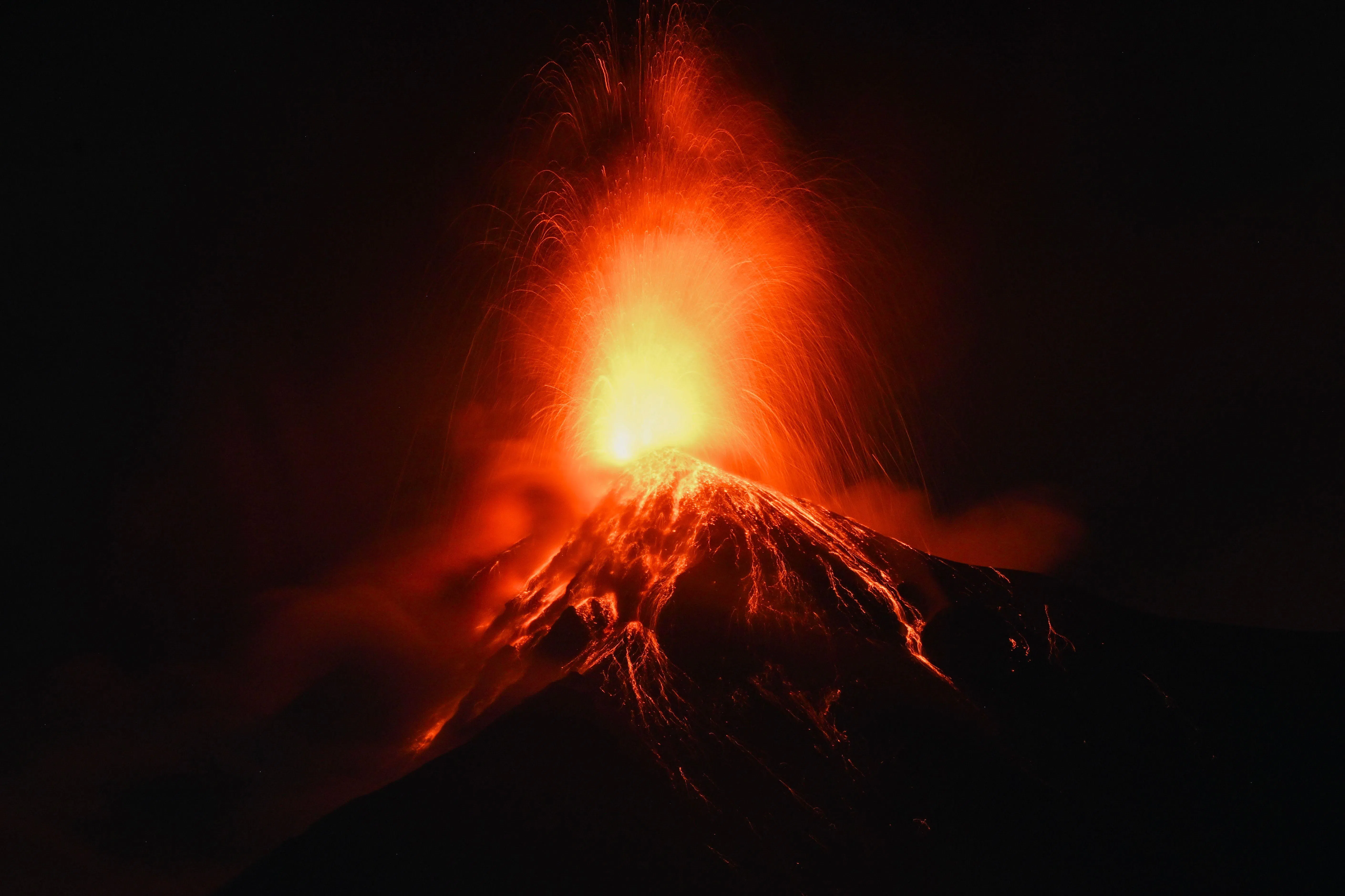 Rivers of lava streamed down the 3,763m-high volcano, while ash rose some 6km into the sky.