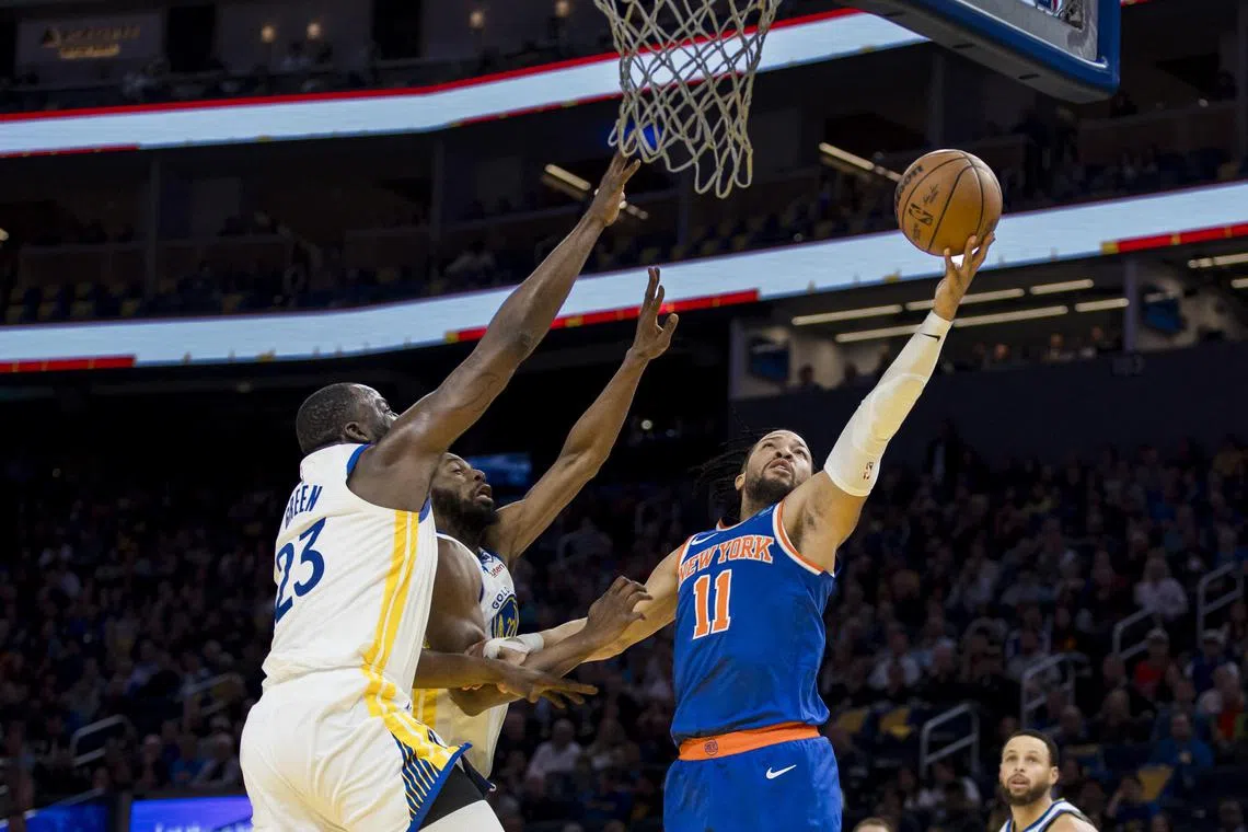 New York Knicks guard Jalen Brunson shoots as Golden State Warriors centre Draymond Green and forward Andrew Wiggins defend during the first half at Chase Centre.