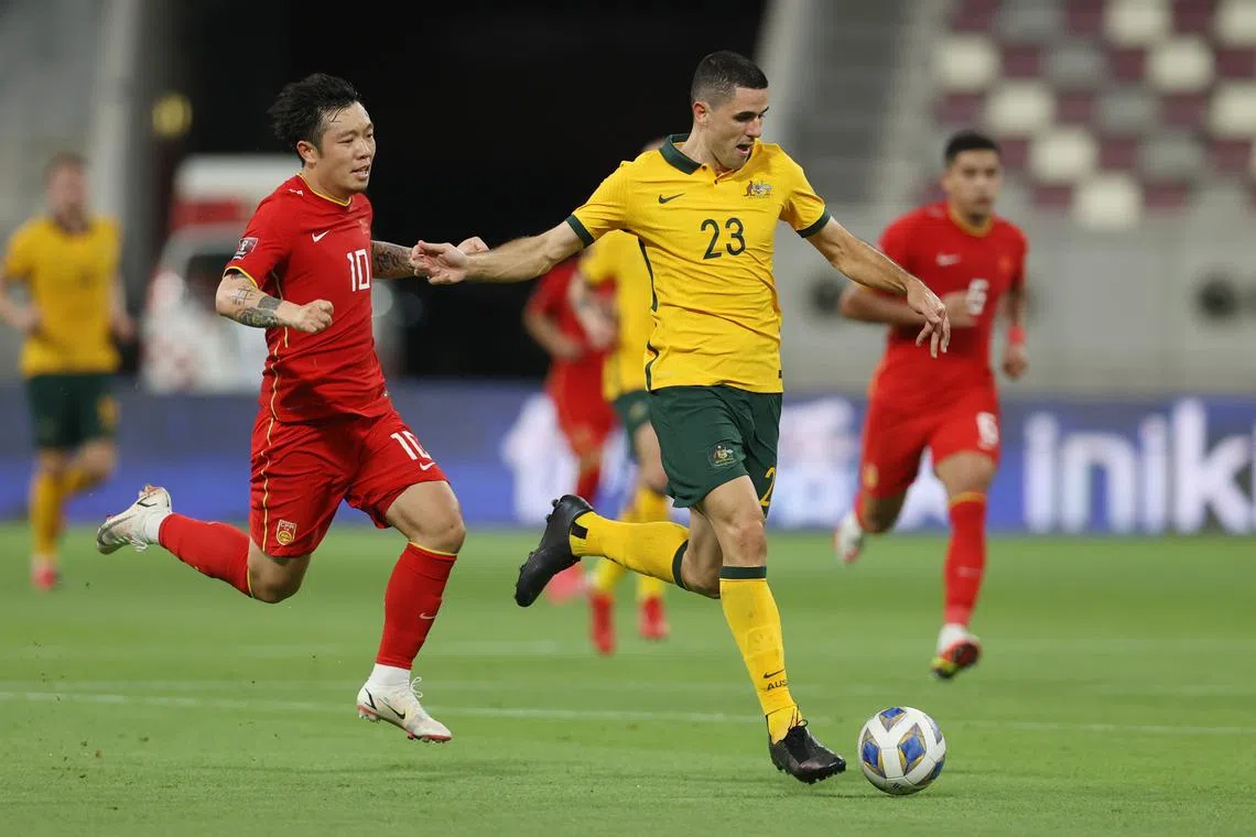 FILE PHOTO: Soccer Football - World Cup - Asia Qualifiers - Group B - Australia v China - Khalifa Stadium, Doha, Qatar - September 2, 2021 Australia's Tom Rogic in action with China's Zhang Xizhe REUTERS/Ibraheem Al Omari