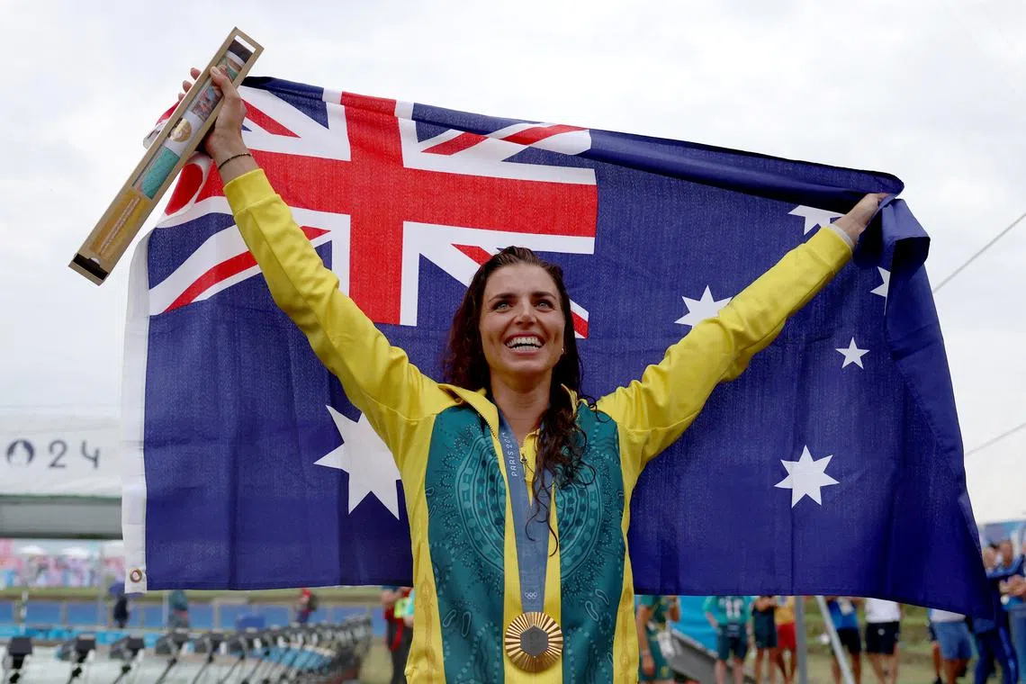 FILE PHOTO: Paris 2024 Olympics - Slalom Canoe - Women's Canoe Single Victory Ceremony - Vaires-sur-Marne Nautical Stadium - Whitewater, Vaires-sur-Marne, France - July 31, 2024. Gold medallist Jessica Fox of Australia holds an Australian flag, as she celebrates after winning. REUTERS/Molly Darlington/File Photo
