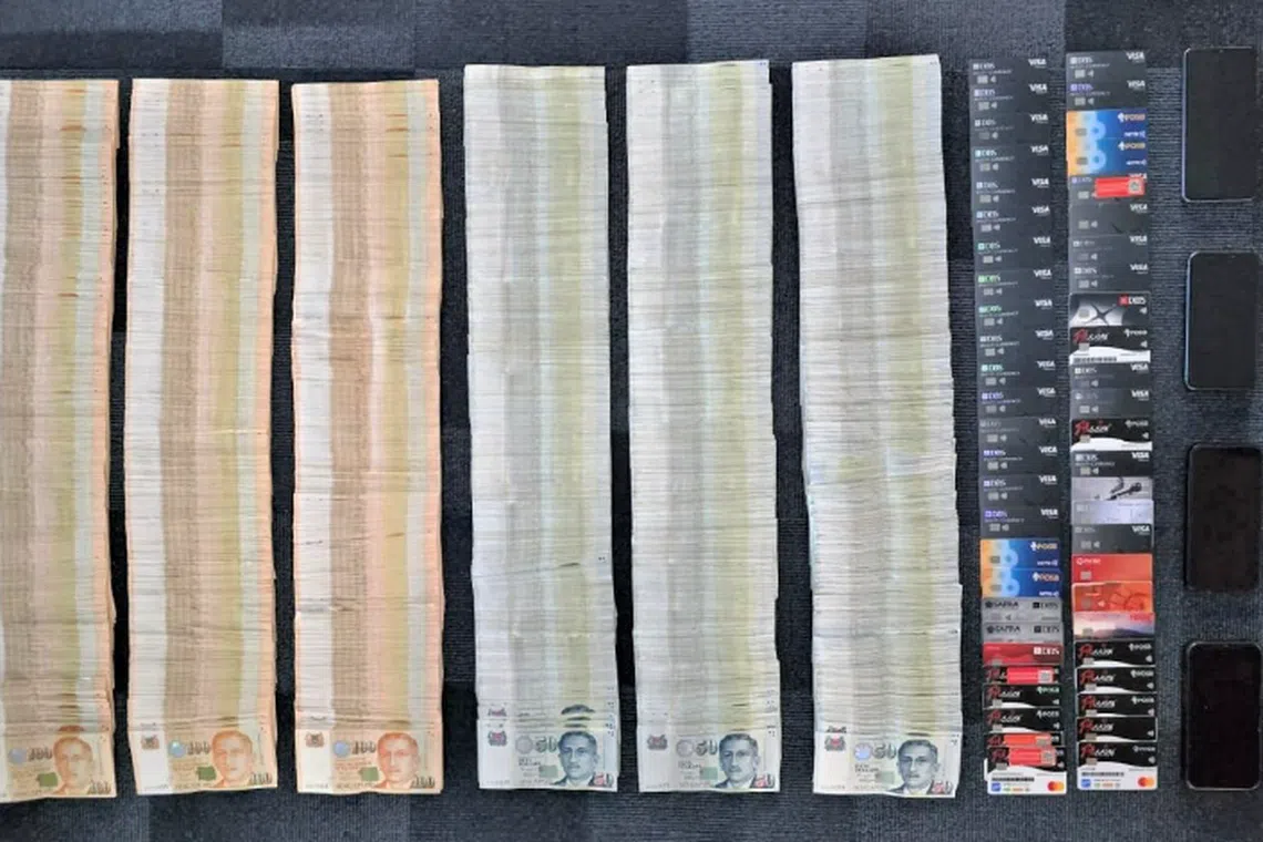 Cash and bank cards were seized as the police nabbed three men allegedly involved in money laundering activities.