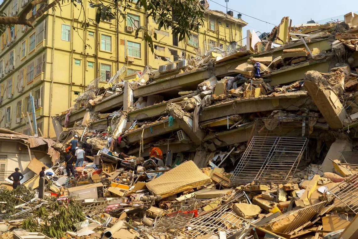 Rescue personnel work at the site of a building that collapsed in Mandalay, Myanmar