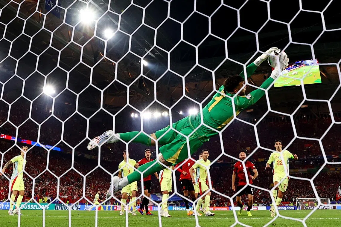 Soccer Football - Euro 2024 - Group B - Albania v Spain - Dusseldorf Arena, Dusseldorf, Germany - June 24, 2024   Spain's David Raya saves from Albania's Armando Broja REUTERS/Bernadett Szabo