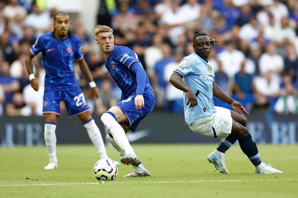 FILE PHOTO: Soccer Football - Premier League - Chelsea v Manchester City - Stamford Bridge, London, Britain - August 18, 2024 Manchester City's Jeremy Doku in action with Chelsea's Cole Palmer Action Images via Reuters/Peter Cziborra/File Photo