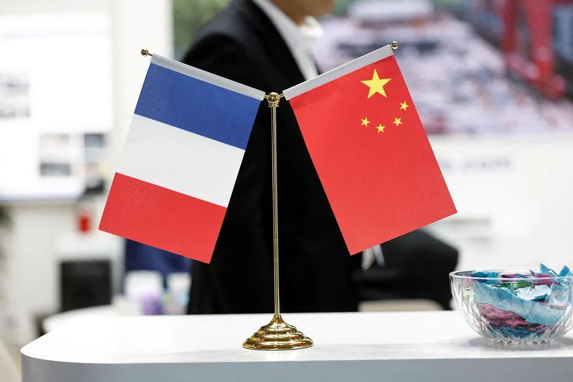 FILE PHOTO: French and Chinese flags are seen at the Wuxi Turbine Blade Co., Ltd stand during the 55th International Paris Airshow at Le Bourget Airport near Paris, France, June 16, 2025. REUTERS/Benoit Tessier/File Photo