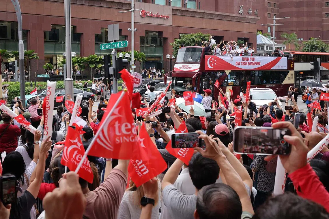 Open-top bus parade to celebrate Team Singapore's Olympians, including bronze medallist Max Maeder passing Orchard Road.
