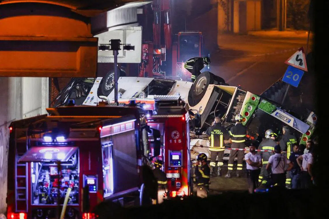 FILE PHOTO: Firefighters and rescue personnel work near a coach after it crashed off an overpass near Venice, in Mestre, Italy, October 4, 2023. REUTERS/Claudia Greco/File Photo