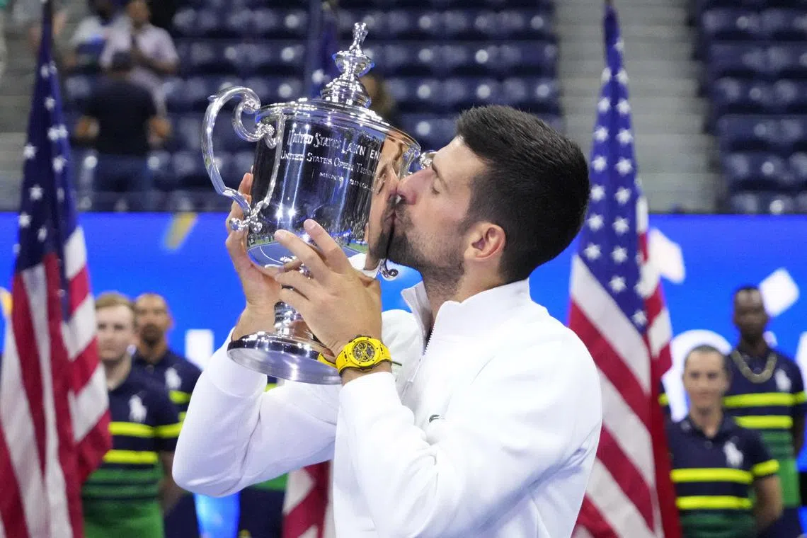 Serbia's Novak Djokovic celebrating with the trophy after winning the US Open.
