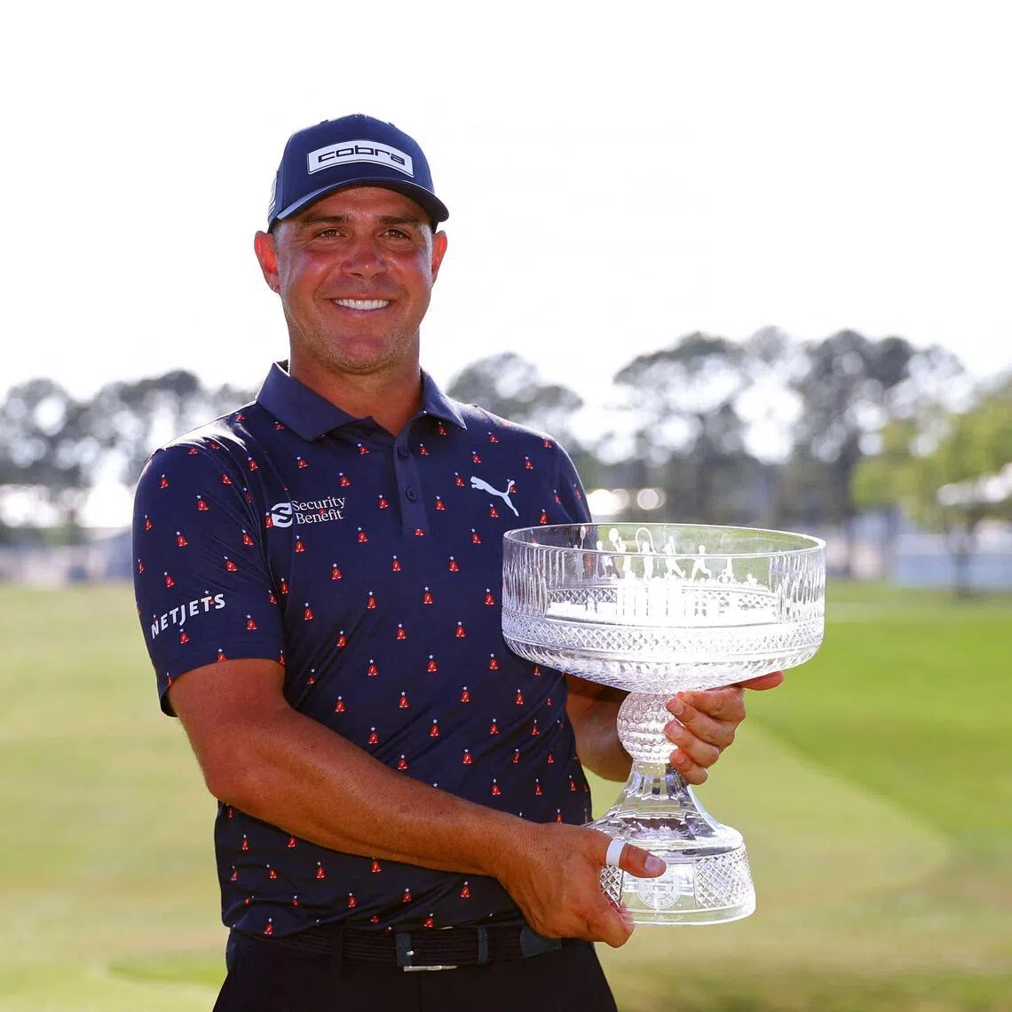 Gary Woodland of the United States poses with the trophy on the 18th green after winning the Texas Children's Houston Open.