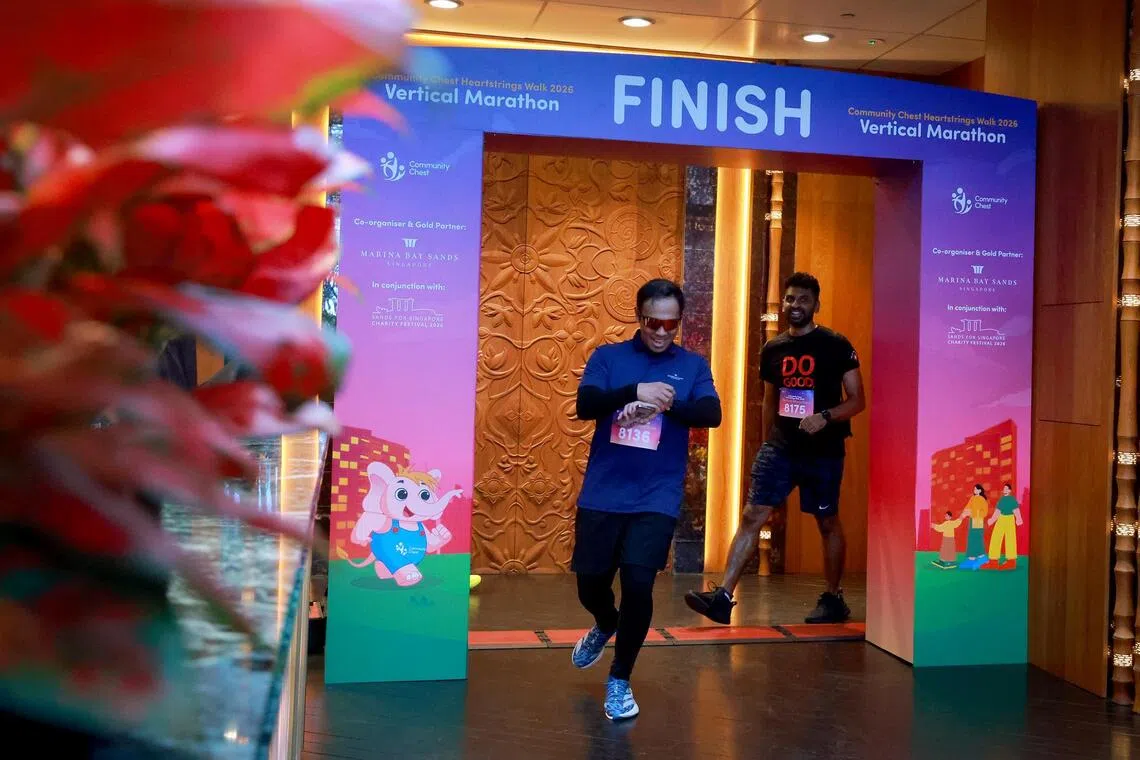 Participants crossing the finish line after scaling 57 floors.