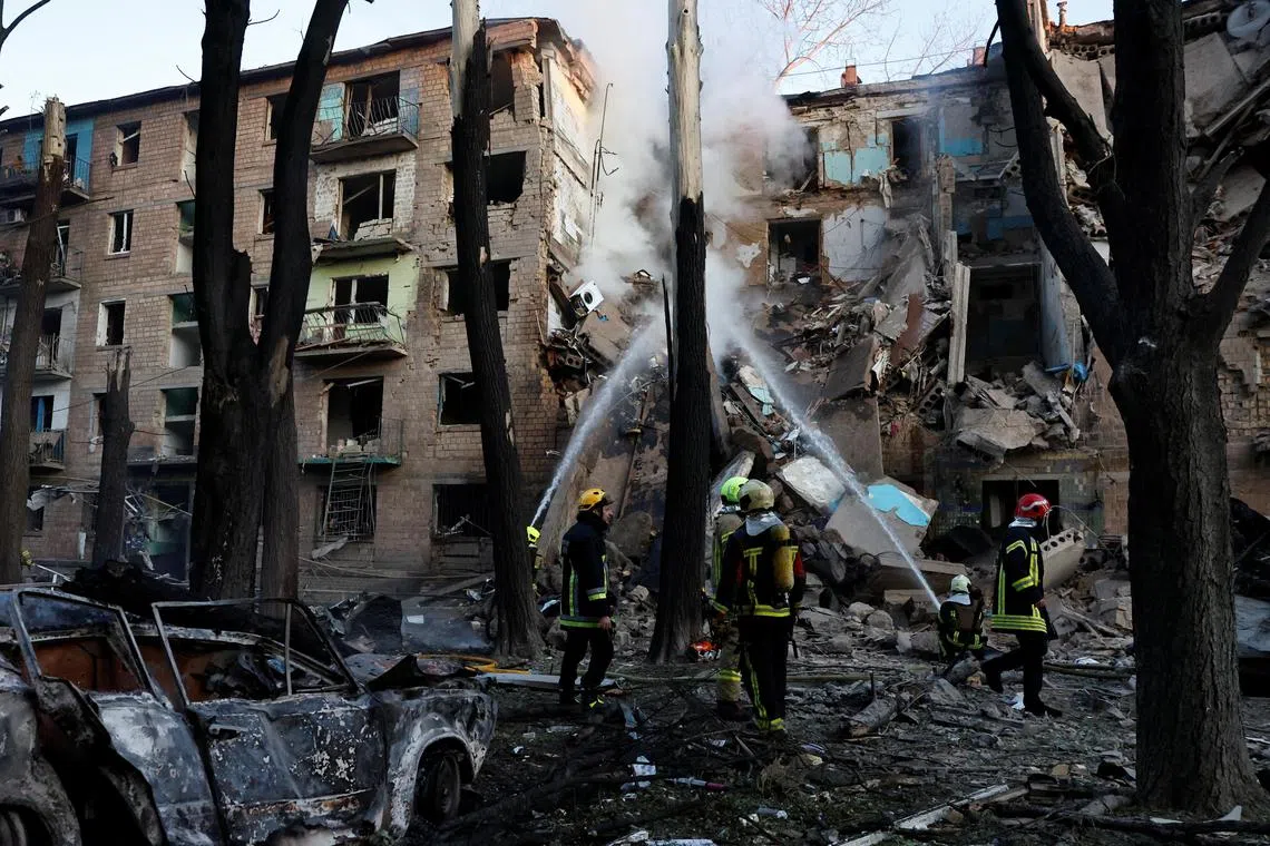 Firefighters work at the site of an apartment building hit during Russian drone and missile strikes, amid Russia's attack on Ukraine, in Kyiv on June 23.