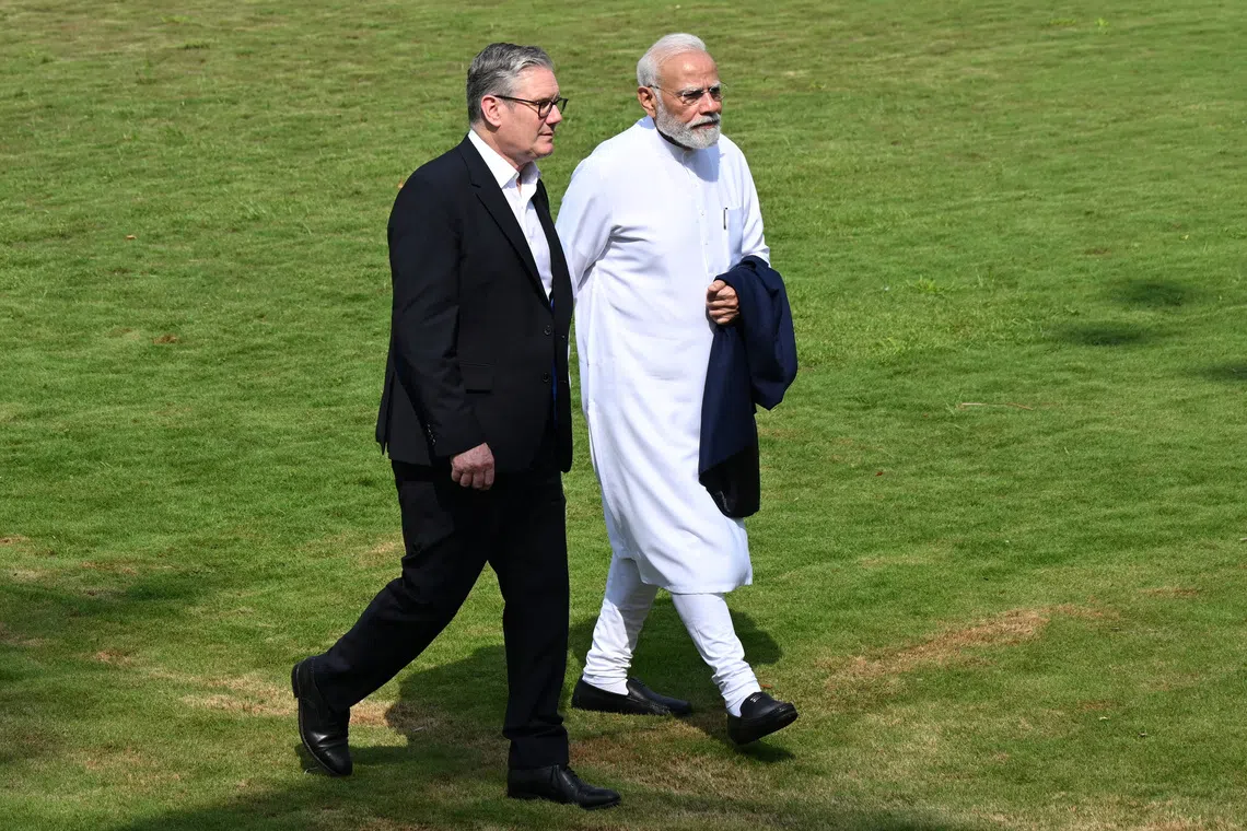 MUMBAI, INDIA - OCTOBER 9:  British Prime Minister Sir Keir Starmer and Indian Prime Minister Narendra Modi walk through the gardens at Raj Bhavan on October 9, 2025 in Mumbai, India. Leon Neal/Pool via REUTERS