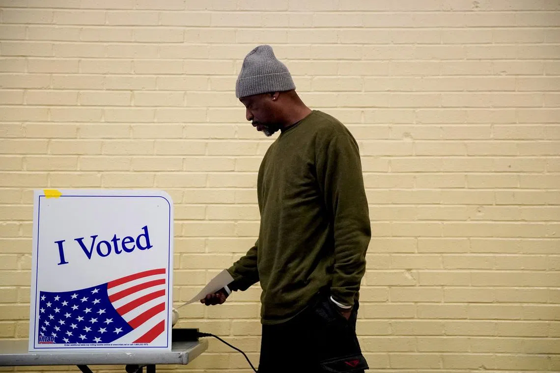 FILE PHOTO: A man votes at a polling station in South Carolina's Democratic presidential primary in Columbia, South Carolina, U.S., February 29, 2020. REUTERS/Eric Thayer/File Photo