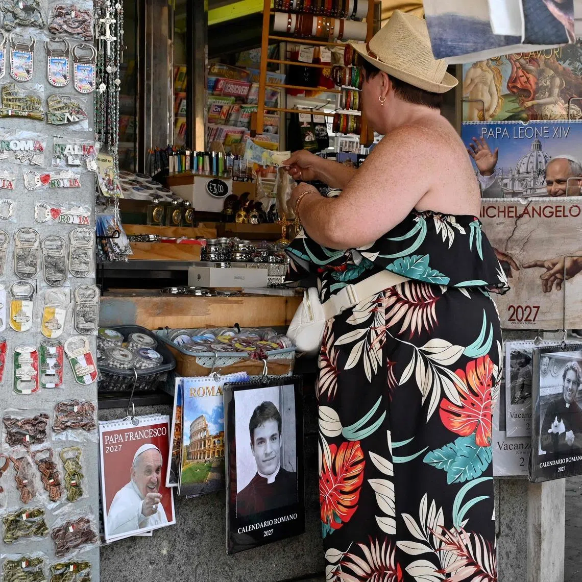 Calendars displaying photos of models dressed as priests on sale in a souvenir shop in Rome on May 18. Mr Giovanni Galizia, who was photographed for the calendar, said he was never a priest.