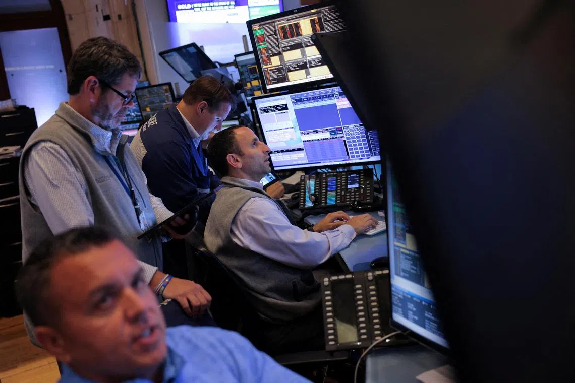 Traders work on the trading floor at the New York Stock Exchange, in New York City.