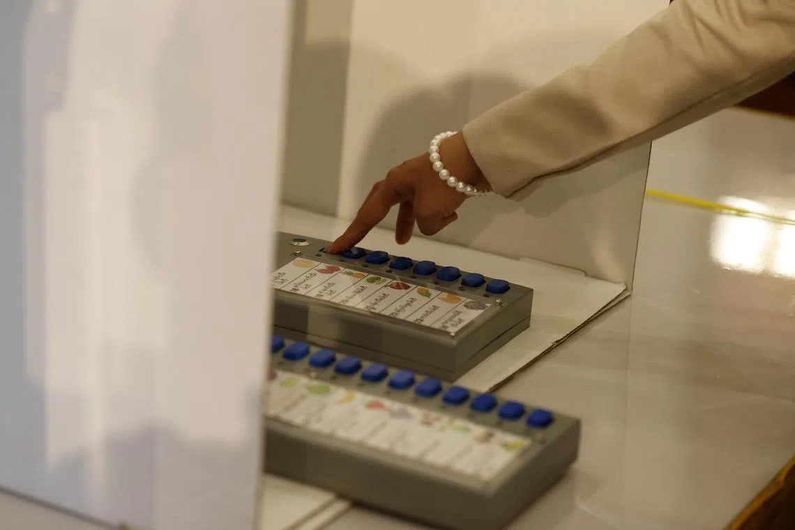 Union Election Commission's staff tests the Myanmar Electronic Voting Machine (MEVM).
