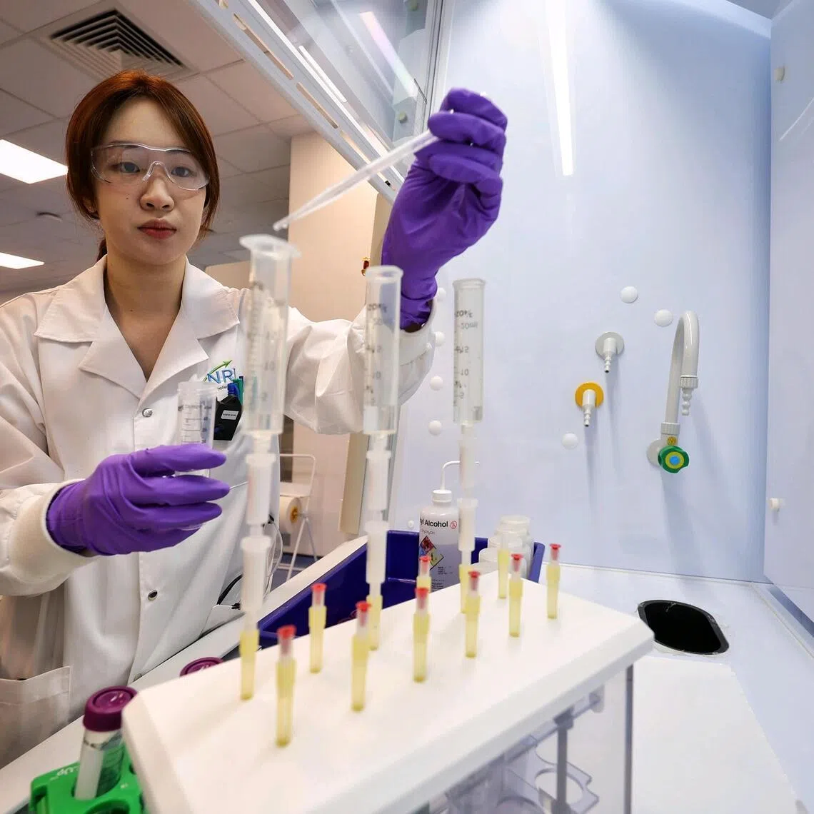 Senior scientific officer Eugenia Wong conducting solid-phase extraction which isolates some radioactive substances at the National Radiochemistry Laboratory under NEA. 
