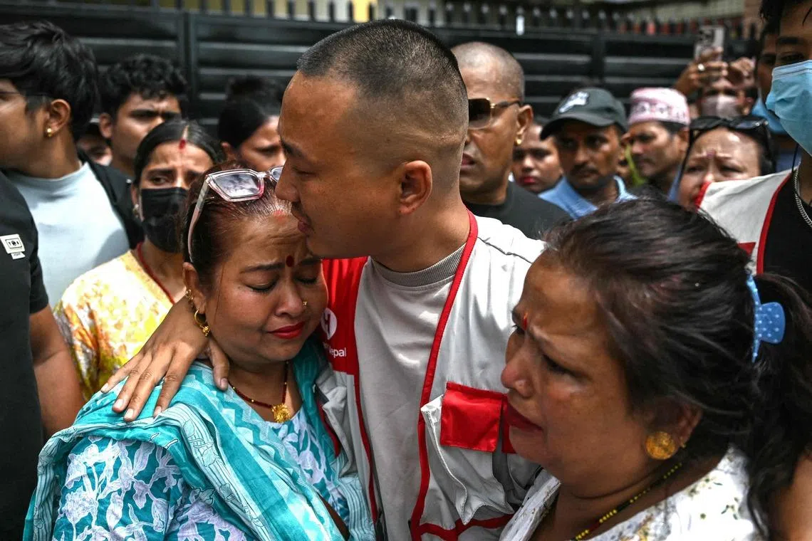 Sudan Gurung (centre), a key figure among the Gen Z protesters, meets with family members of a victim, who died during anti-corruption clashes with security personnel.