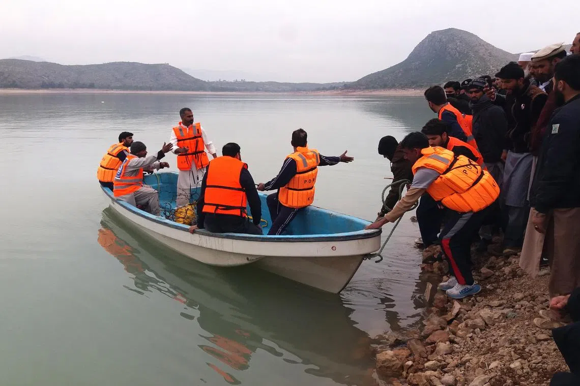Rescue workers perform a search operation for bodies after a boat capisized in Kohat dam, Pakistan, on Jan 29, 2023. 