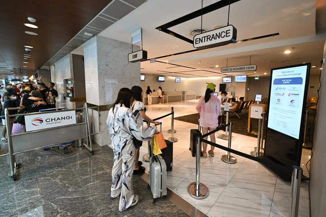 Passengers at an early check-in lounge at Changi Airport Terminal 1 on June 22, 2023.