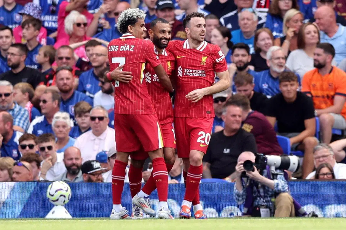 Liverpool's Mohamed Salah celebrates scoring their second goal with Luis Diaz and Diogo Jota in the 2-0 win over Ipswich Town.