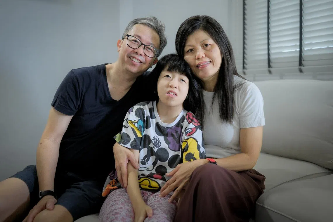 Cheong Chel Sie, 20, who suffers from a chromosome disorder and autism, with her parents Mr Cheong Weng Thim, 52, and Madam Chan Fui Lee, 54.