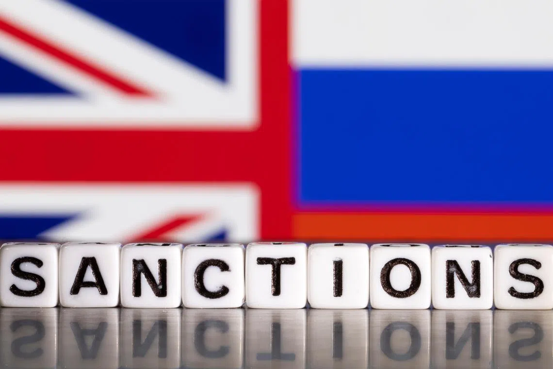 FILE PHOTO: Plastic letters arranged to read \"Sanctions\" are placed in front the Union Jack and Russian flag colors in this illustration taken February 28, 2022. REUTERS/Dado Ruvic/Illustration/File Photo