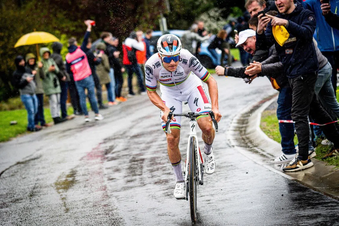 Soudal Quick-Step's Belgian rider Remco Evenepoel is cheered by supporters as he rides before winnig the men's elite race.