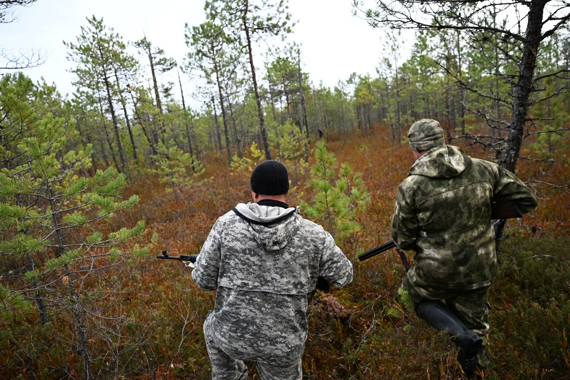 Hunters take part in a bear hunt outside the settlement of Podtesovo, located on the banks of the Yenisei River amid the Siberian taiga on Sept 27.