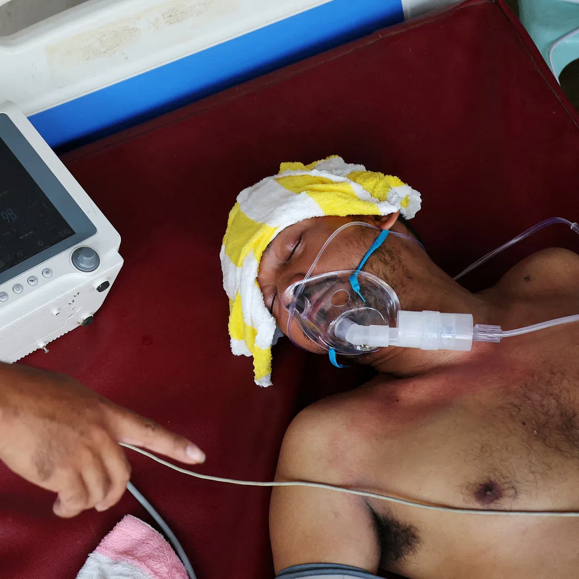 An injured Cambodian soldier getting medical treatment upon his arrival at a hospital in Banteay Meanchey province on Dec 14.