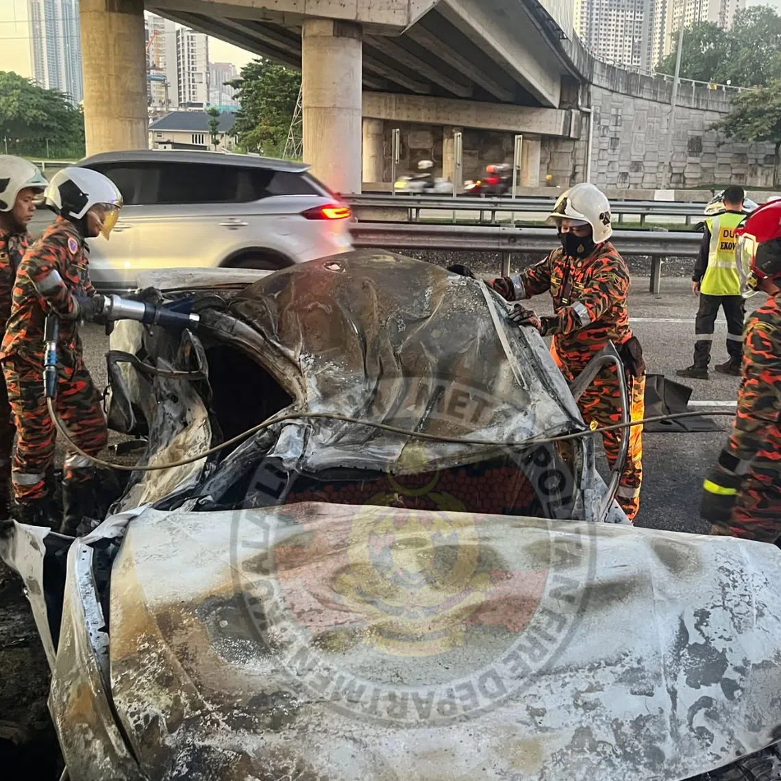 A sports car carrying three passengers caught fire after the driver lost control of the vehicle and crashed into a road divider on the Duta-Ulu Kelang Expressway on June 27.
